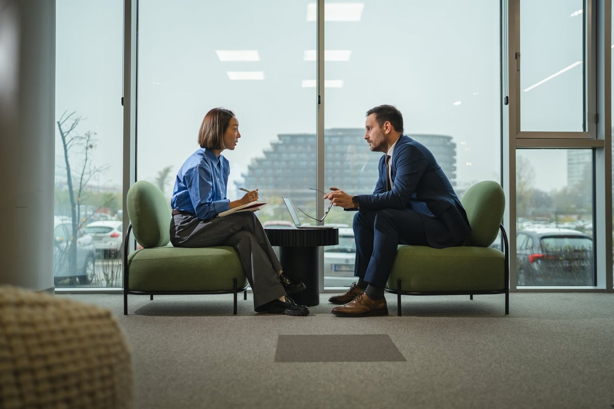 Two professionals in a consulting meeting reviewing a strategic plan